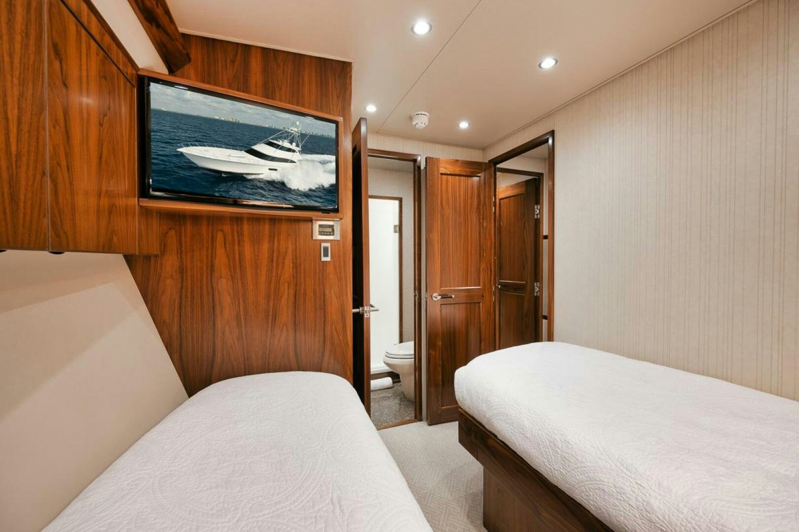 a bedroom with a bed and a television aboard FA-LA-ME Yacht for Sale