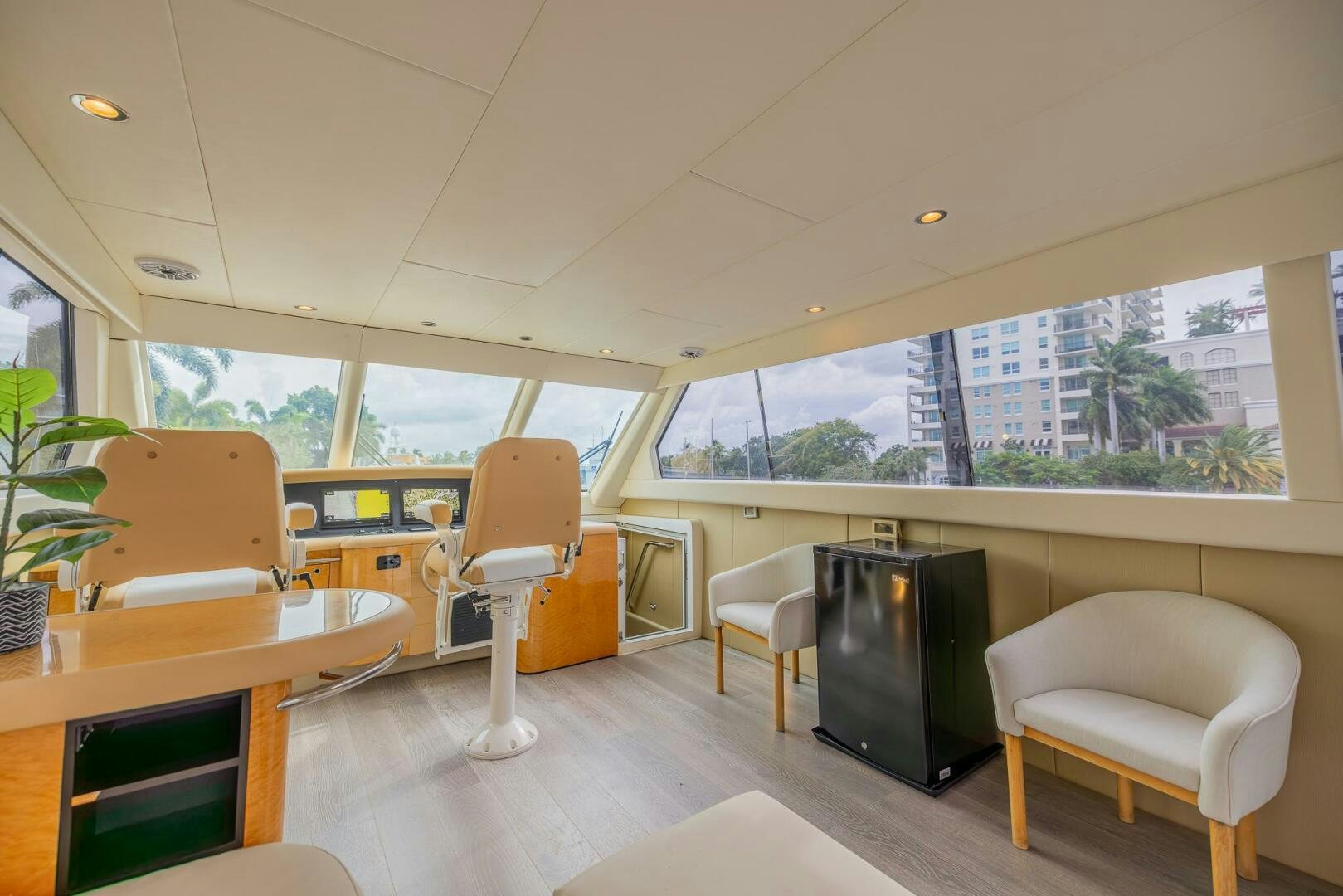 a room with a tv and a table and chairs aboard BOURBON LEGEND Yacht for Sale