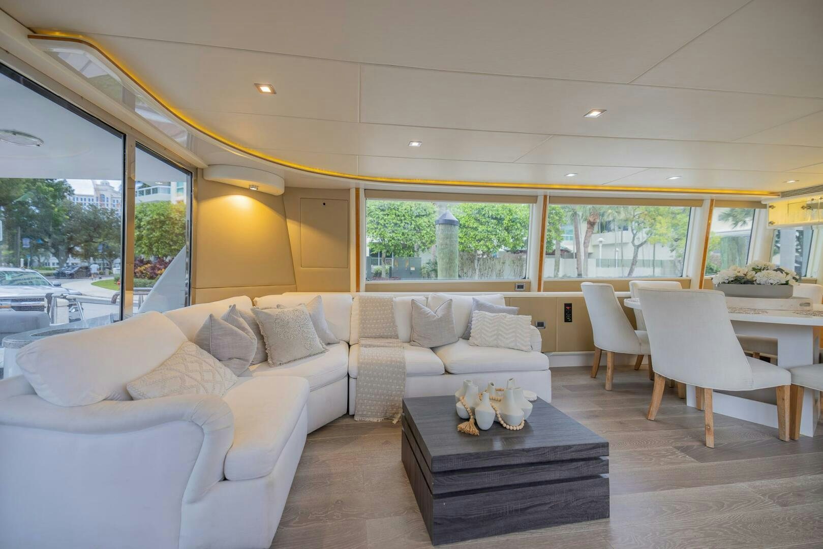 a living room with a large window aboard BOURBON LEGEND Yacht for Sale