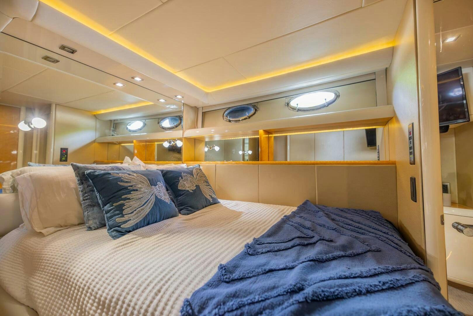 a bed with blue sheets aboard BOURBON LEGEND Yacht for Sale