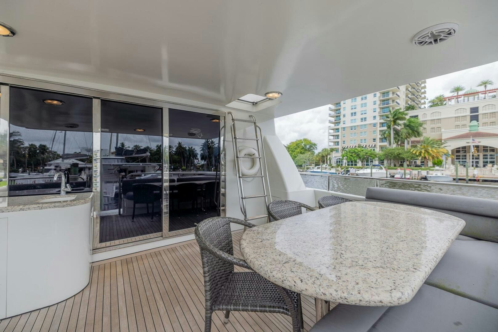 a table and chairs on a deck aboard BOURBON LEGEND Yacht for Sale