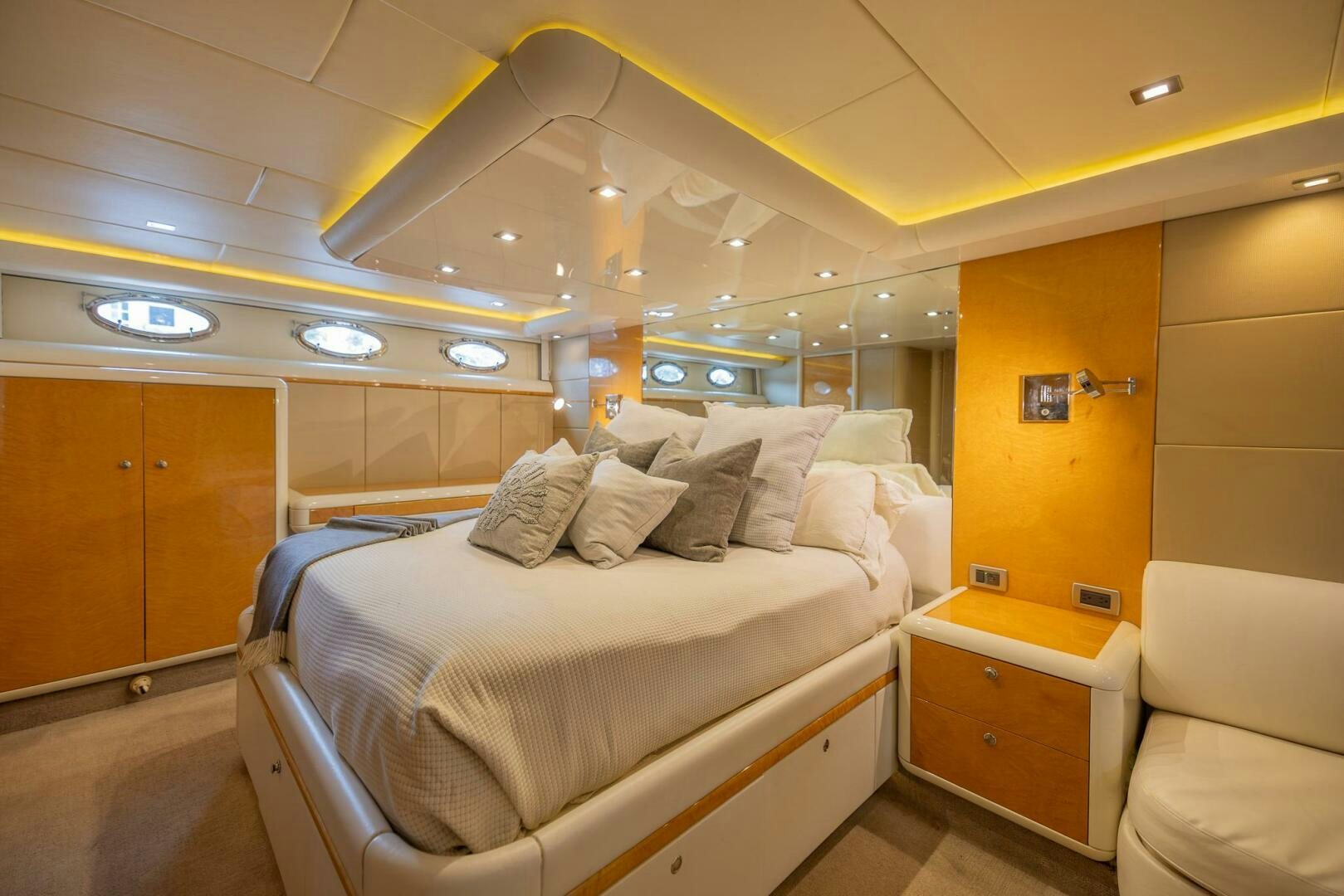 a room with a bed and a chair aboard BOURBON LEGEND Yacht for Sale
