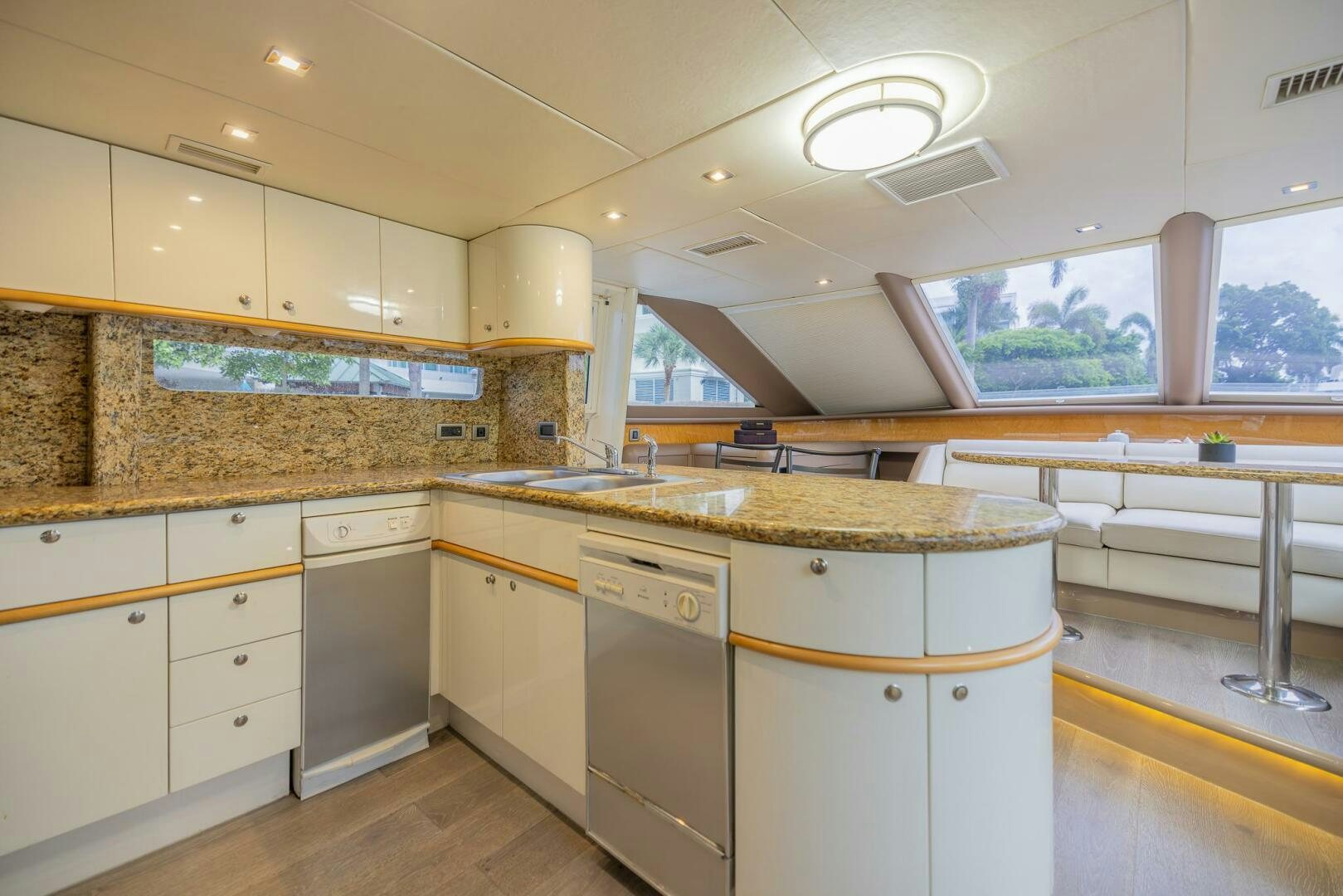a kitchen with white cabinets aboard BOURBON LEGEND Yacht for Sale
