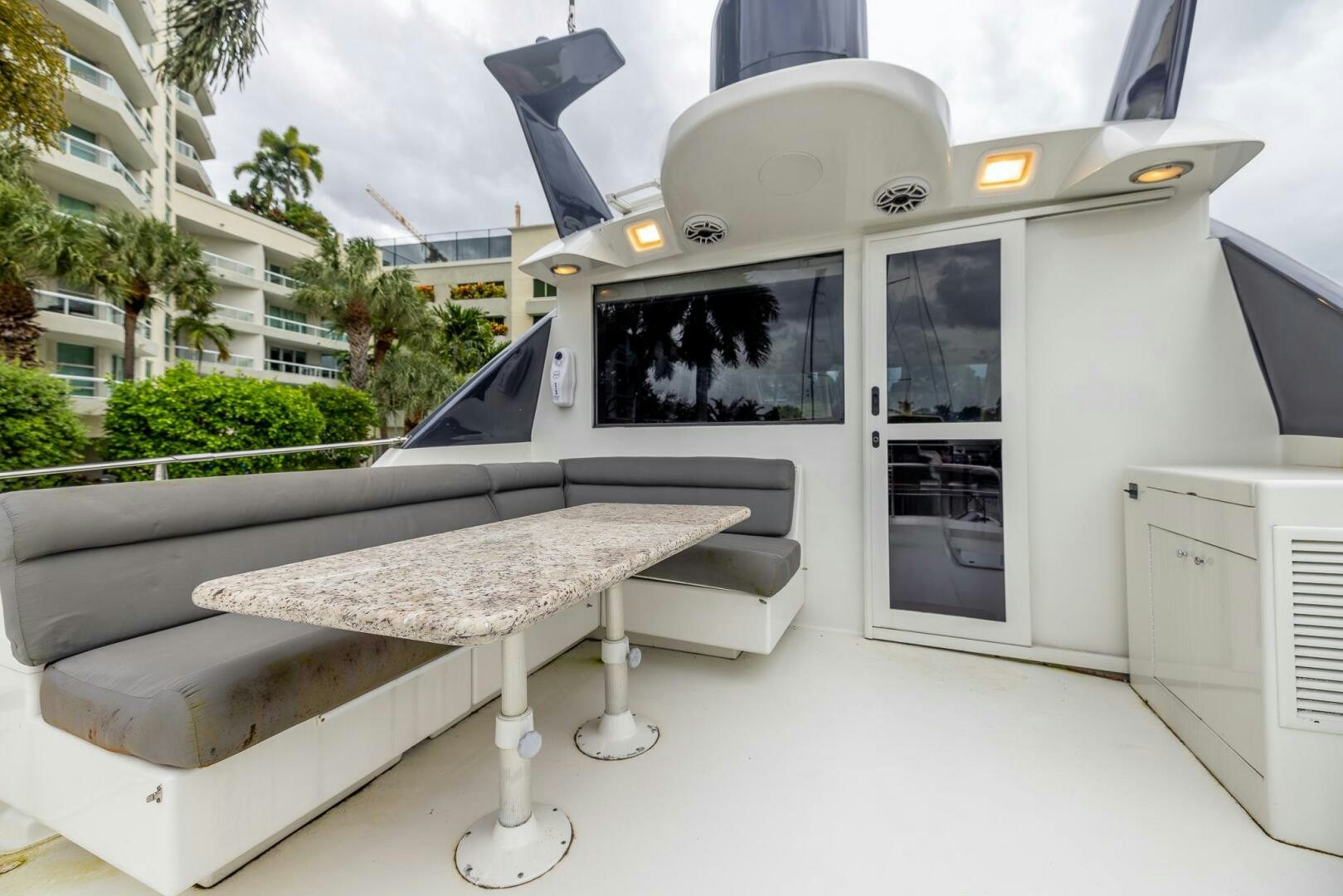 a white vehicle with a round table aboard BOURBON LEGEND Yacht for Sale