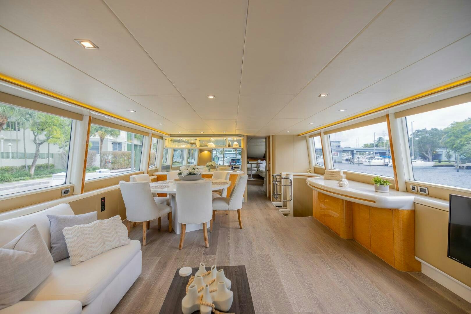 a living room with a large window aboard BOURBON LEGEND Yacht for Sale