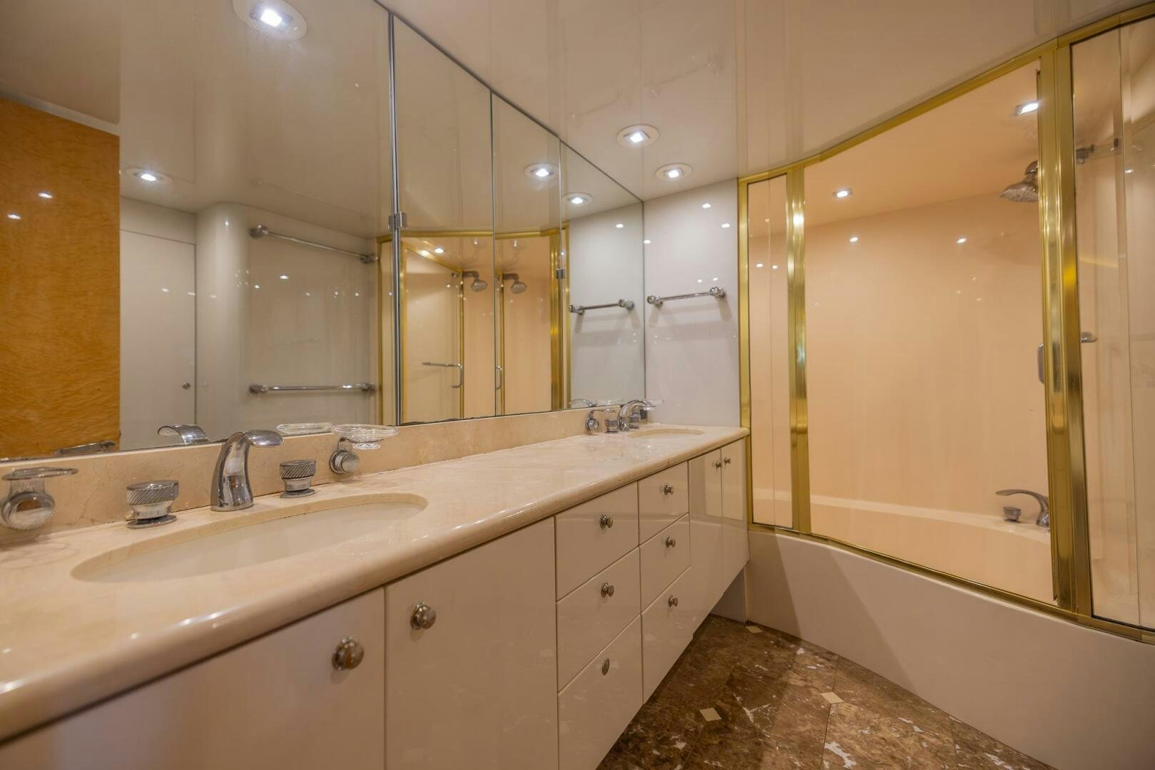 a bathroom with a large mirror aboard BOURBON LEGEND Yacht for Sale
