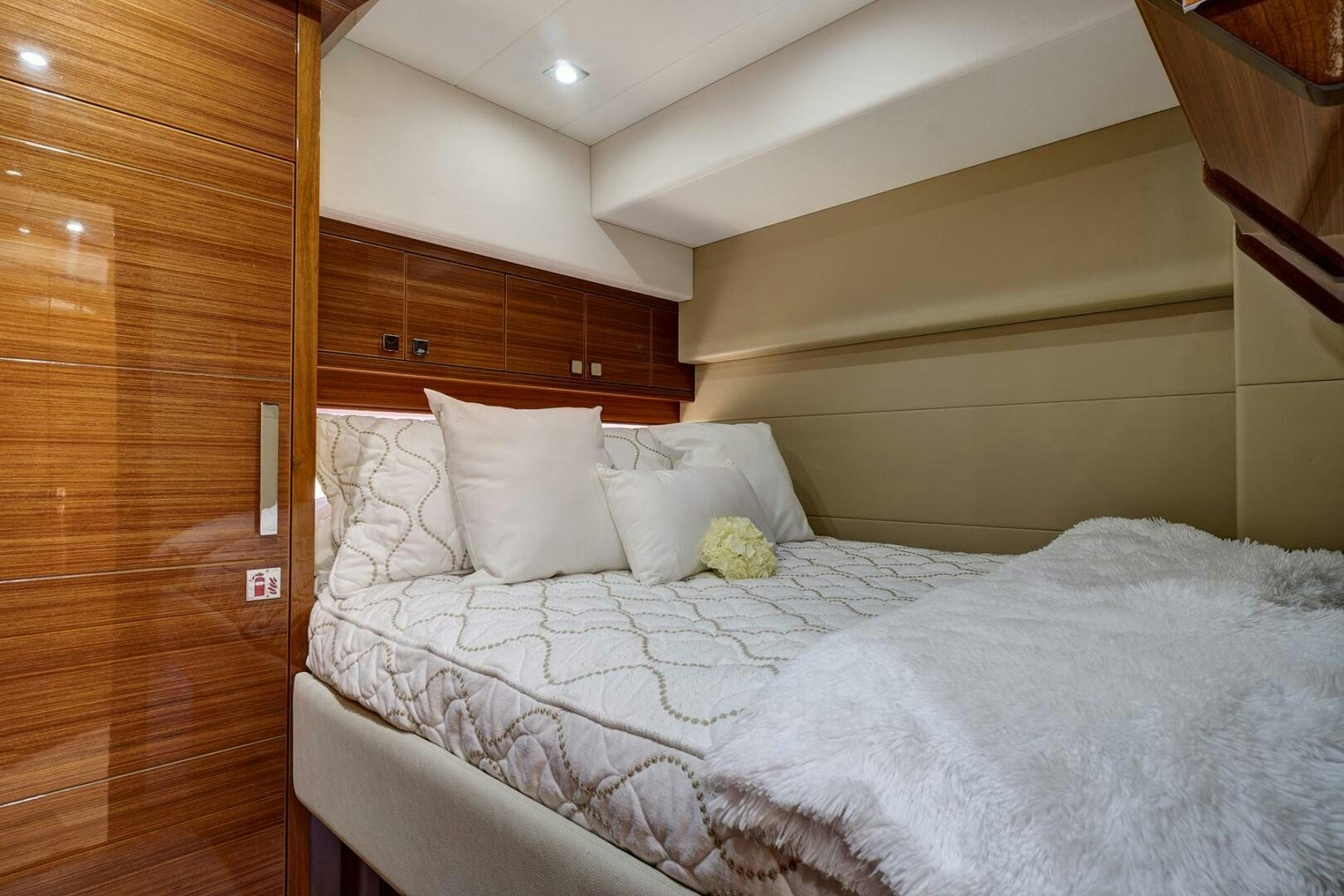 a bed with white sheets aboard DREAM Yacht for Sale