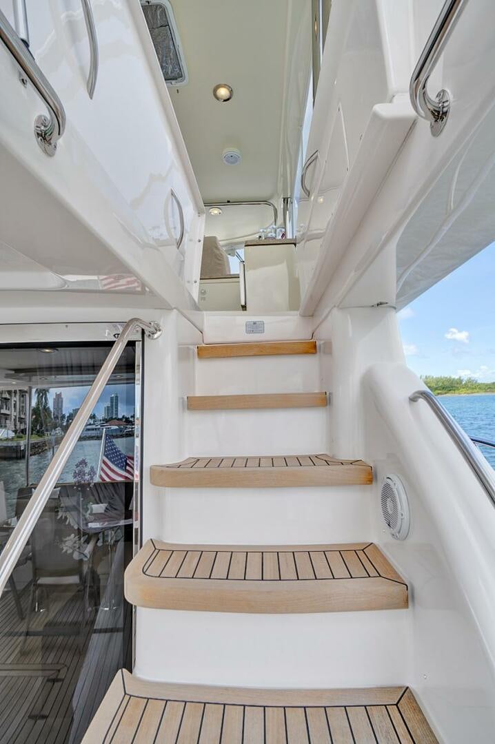 a boat with a flag on the front aboard DREAM Yacht for Sale