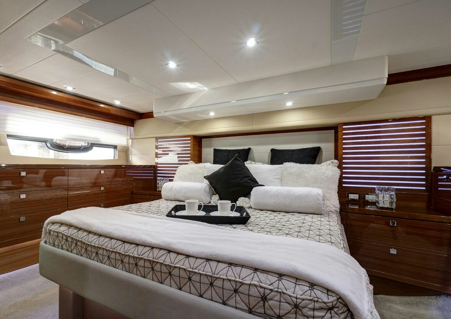 a bed with a white bed spread aboard DREAM Yacht for Sale