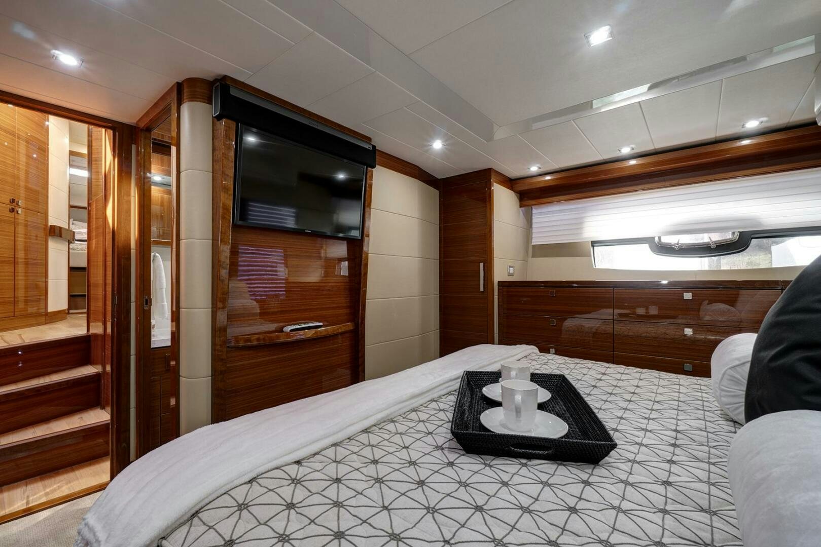 a room with a bed and a television aboard DREAM Yacht for Sale