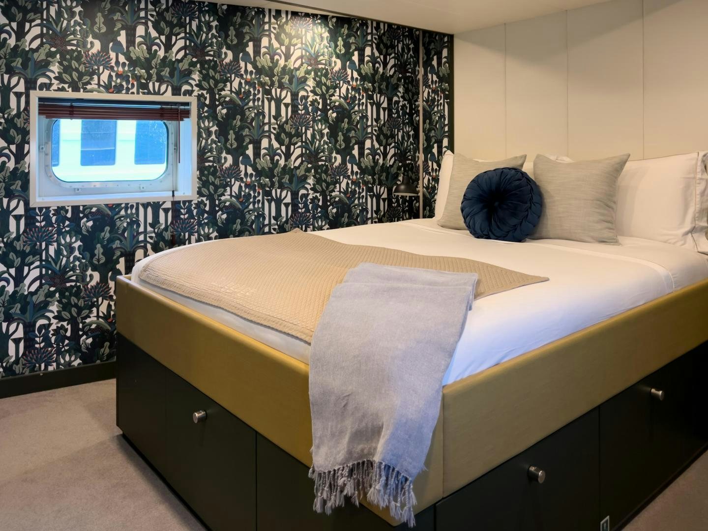 a bed with a pillow and a television on the wall aboard BAD COMPANY SUPPORT Yacht for Sale