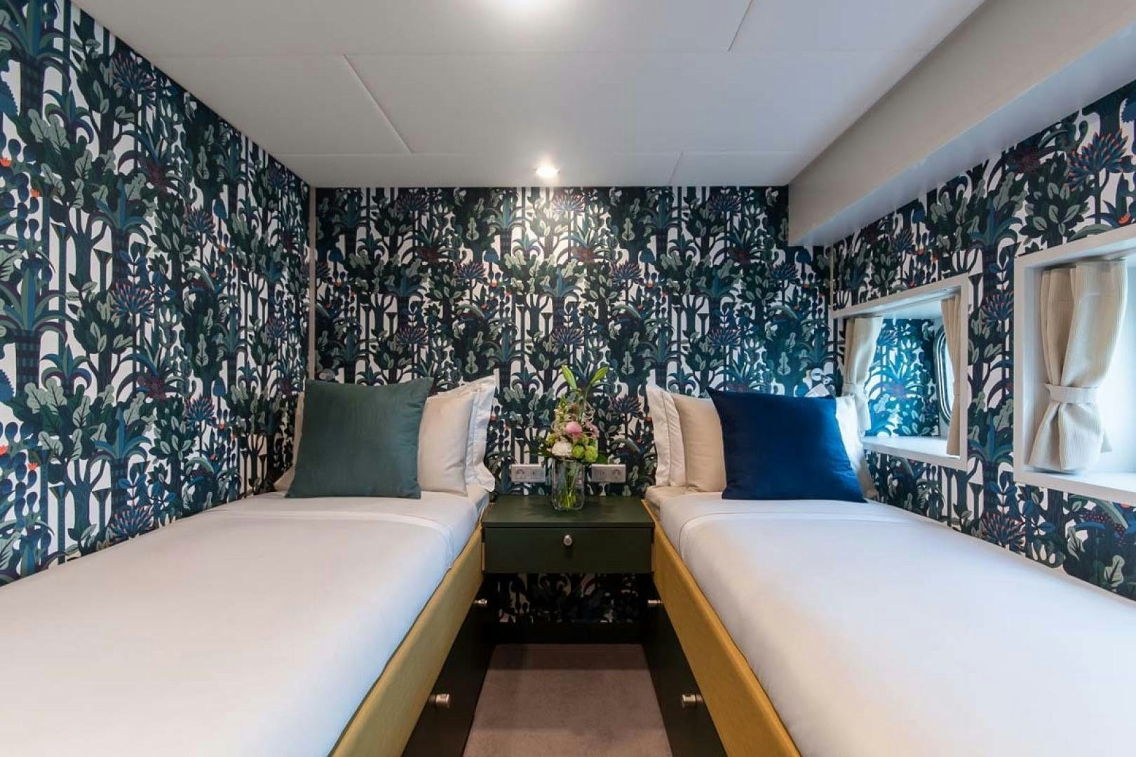 a bedroom with two beds aboard BAD COMPANY SUPPORT Yacht for Sale