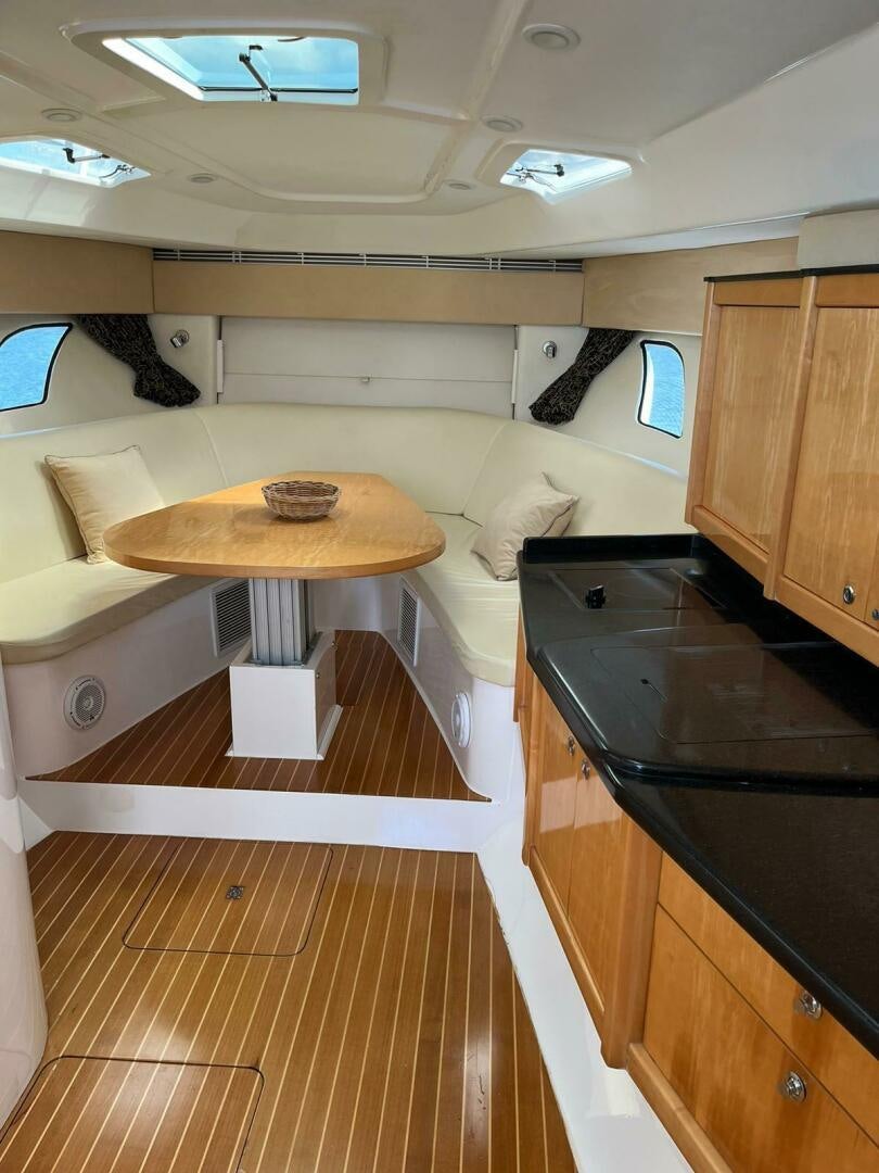 a kitchen with a table and a couch aboard Forget about it. Yacht for Sale