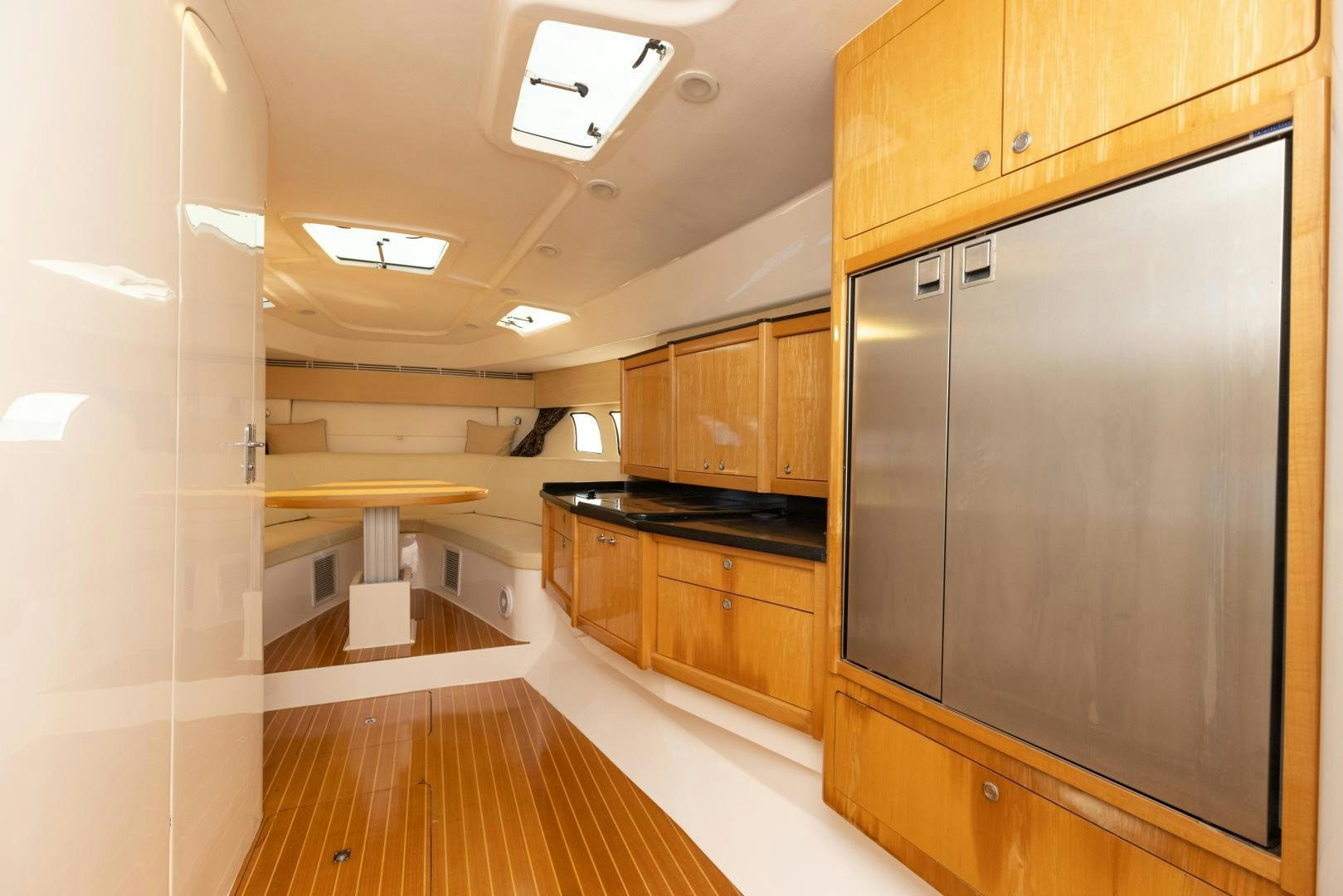 a large kitchen with a large refrigerator aboard Forget about it. Yacht for Sale