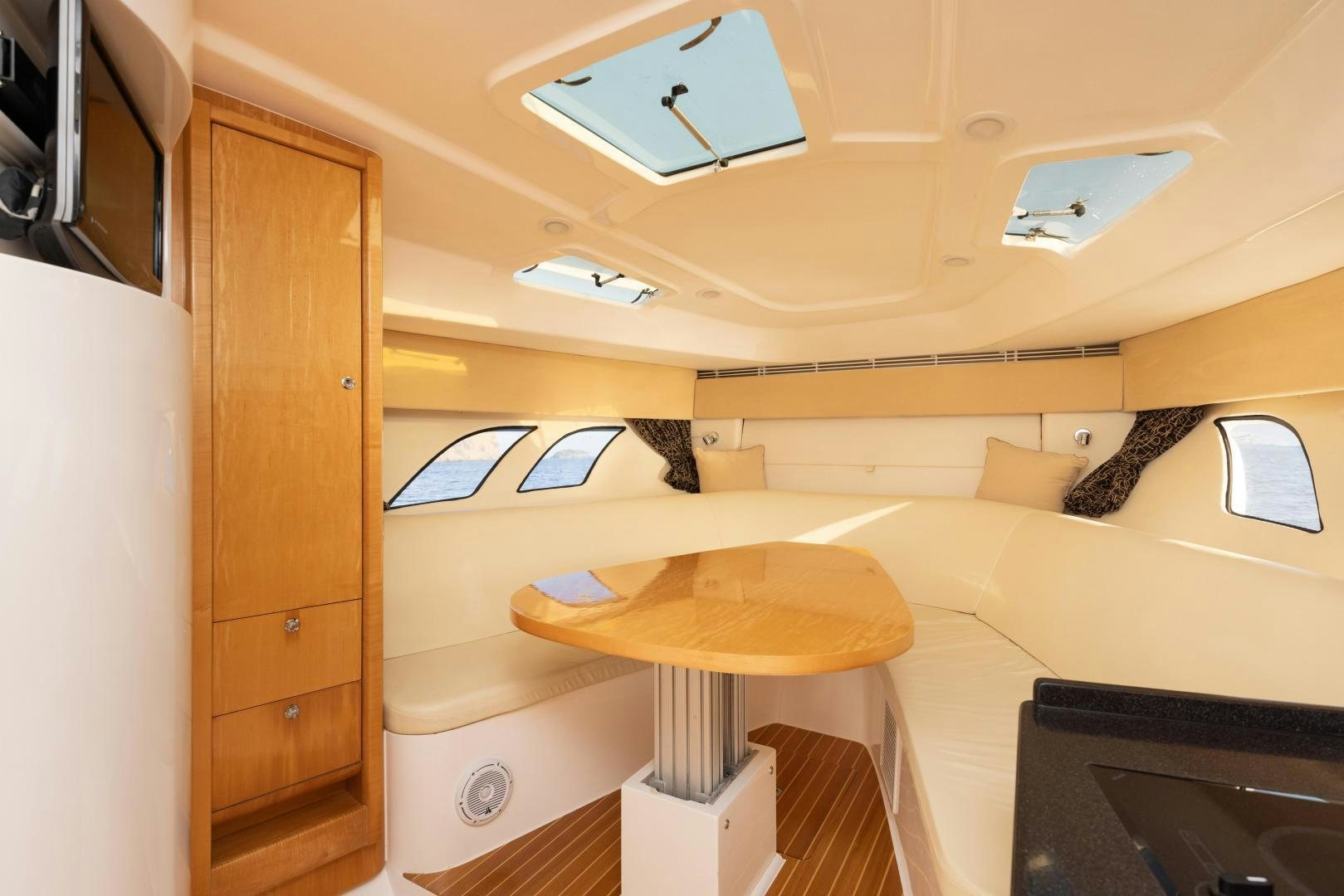 a room with a table and a tv aboard Forget about it. Yacht for Sale