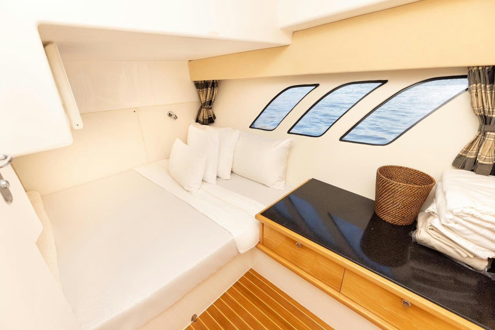 a room with a bed and a table aboard Forget about it. Yacht for Sale