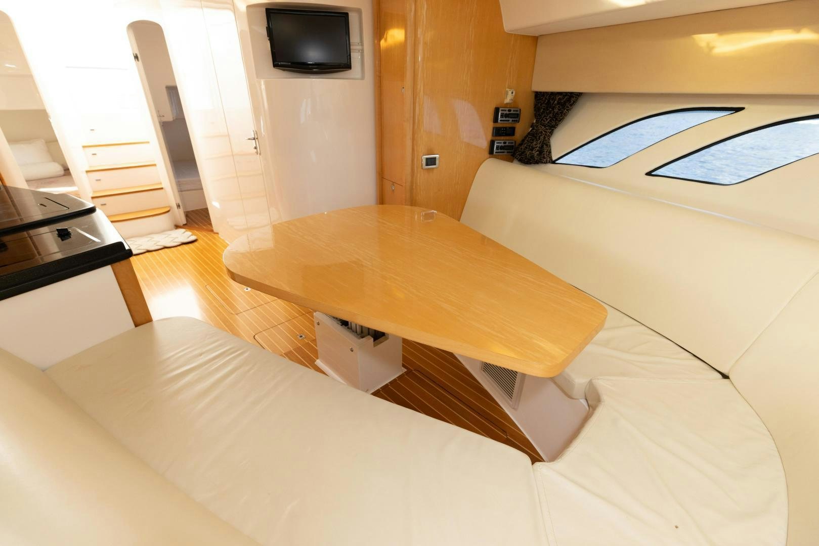 a room with a table and tv aboard Forget about it. Yacht for Sale