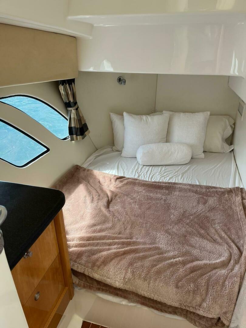 a bed with white pillows aboard Forget about it. Yacht for Sale