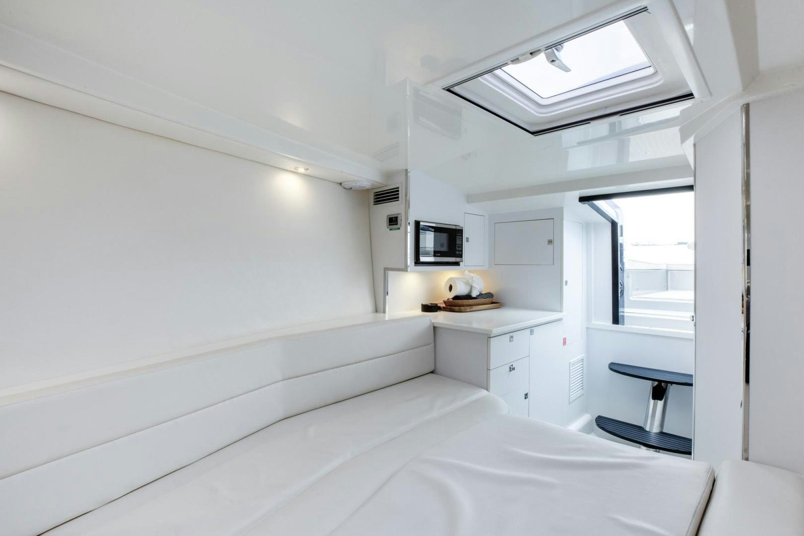 a white bedroom with a bed aboard SVG II Yacht for Sale