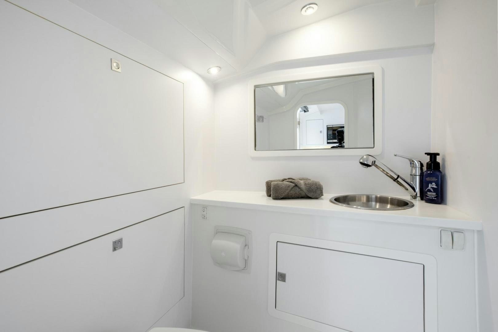 a white bathroom with a mirror aboard SVG II Yacht for Sale