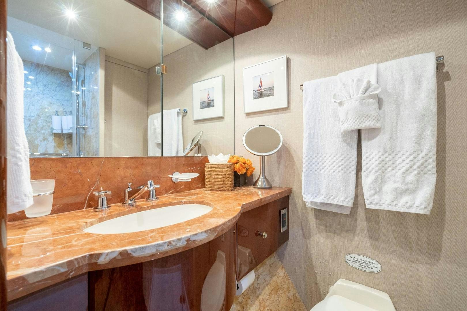 a bathroom with a sink and towels aboard NAMASTAY Yacht for Sale