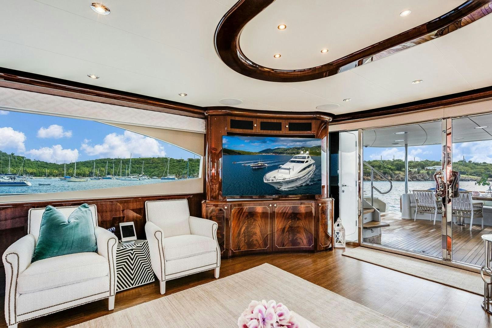 a large living room with a large glass door aboard NAMASTAY Yacht for Sale