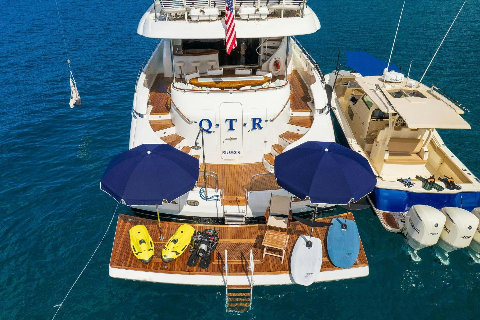 a boat with a blue umbrella on it aboard NAMASTAY Yacht for Sale