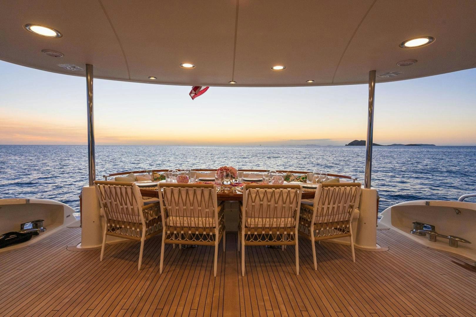 a group of chairs on a deck overlooking the ocean aboard NAMASTAY Yacht for Sale
