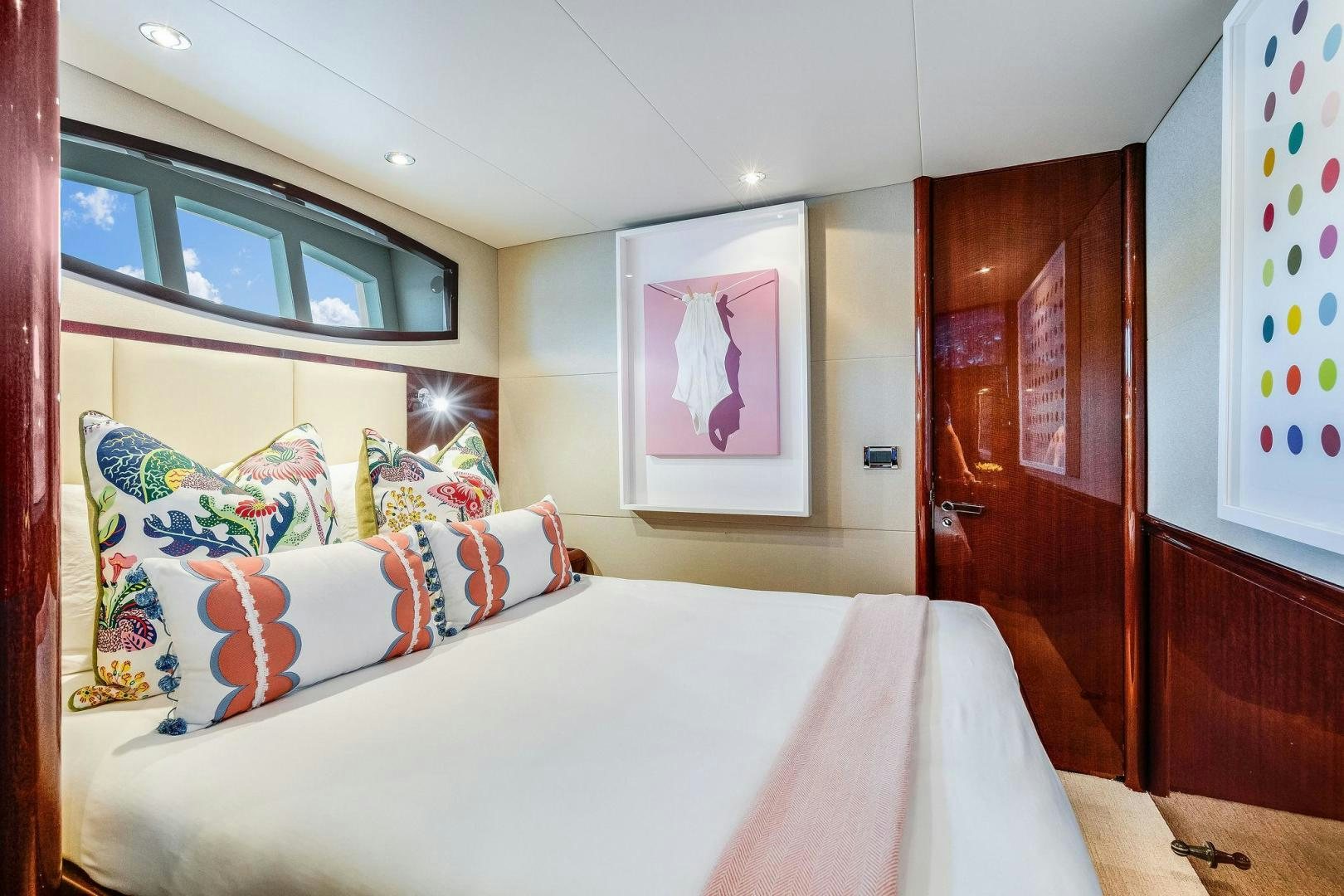 a bed with white sheets and pillows aboard NAMASTAY Yacht for Sale