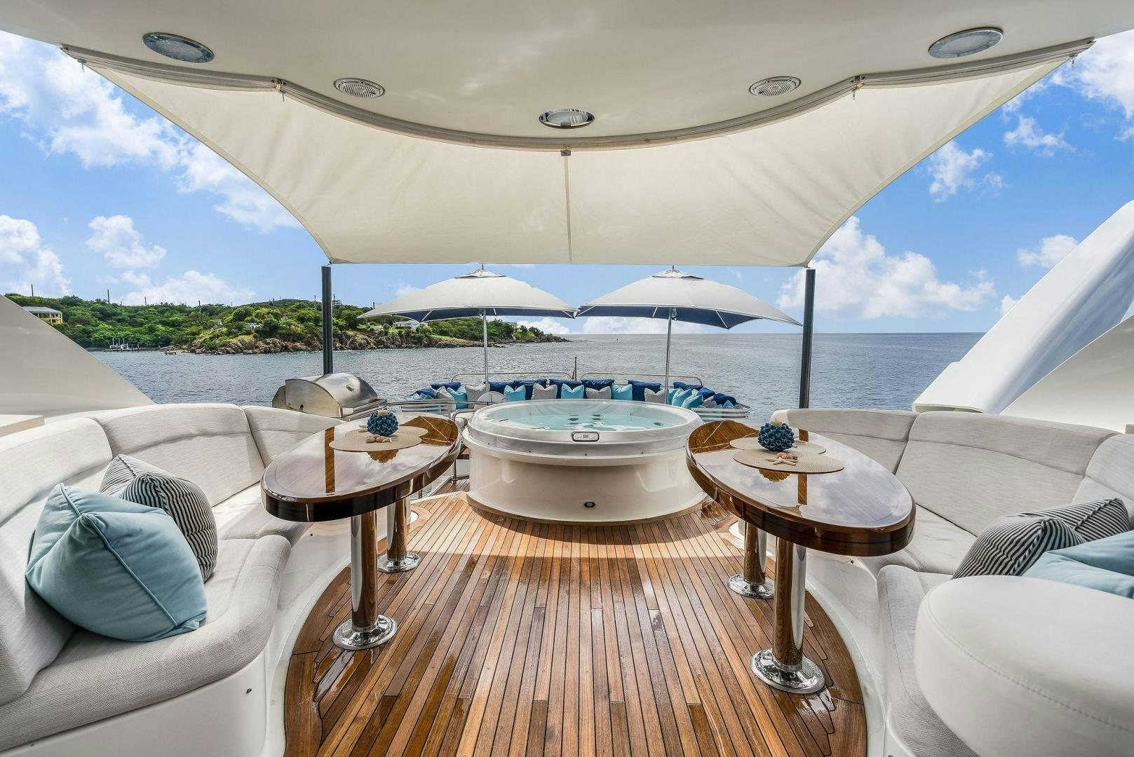 a table and chairs on a deck aboard NAMASTAY Yacht for Sale