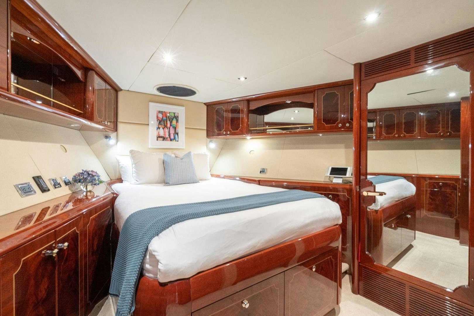 a bedroom with a bed and a desk aboard NAMASTAY Yacht for Sale