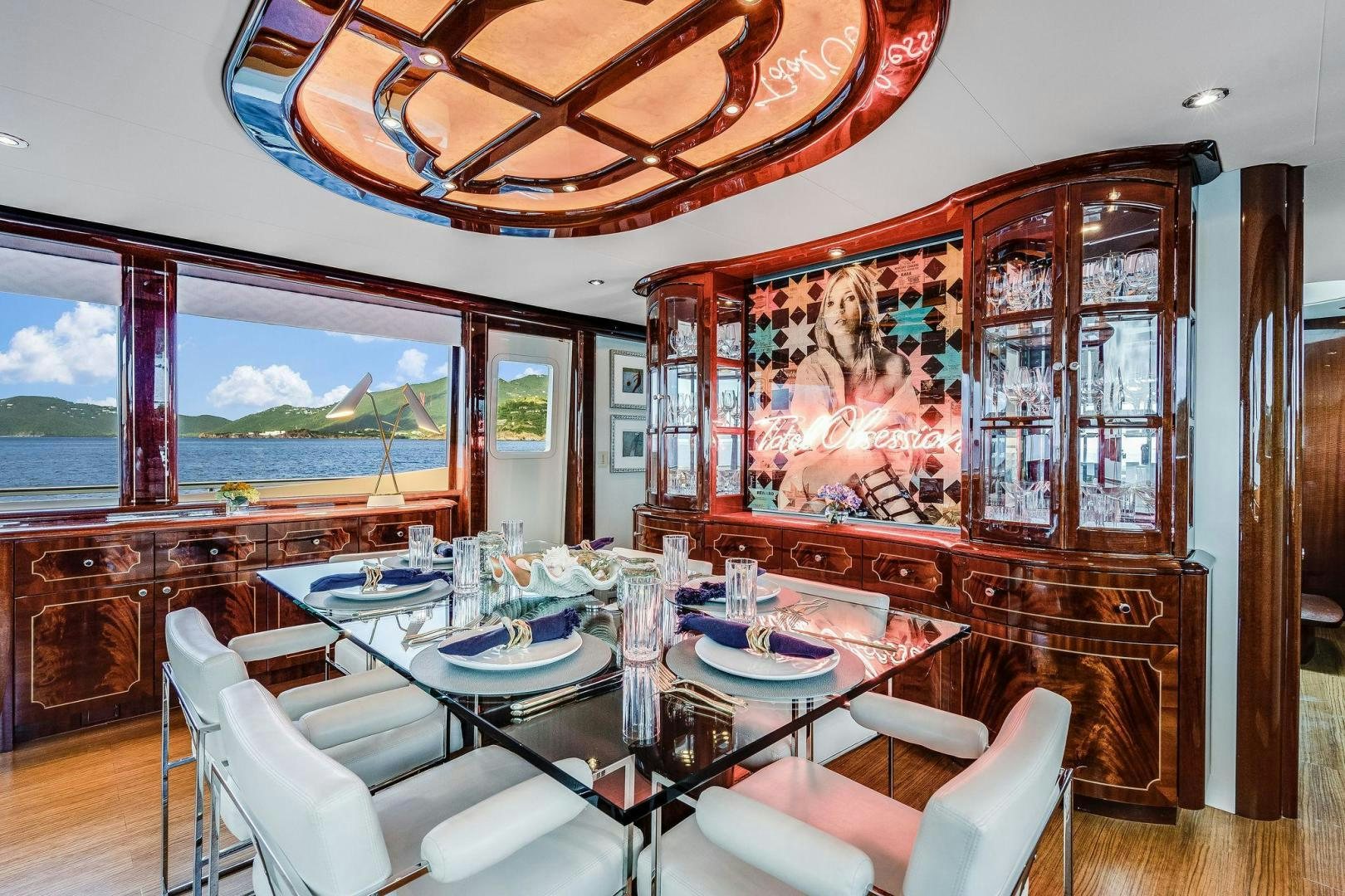 a dining room with a large window aboard NAMASTAY Yacht for Sale