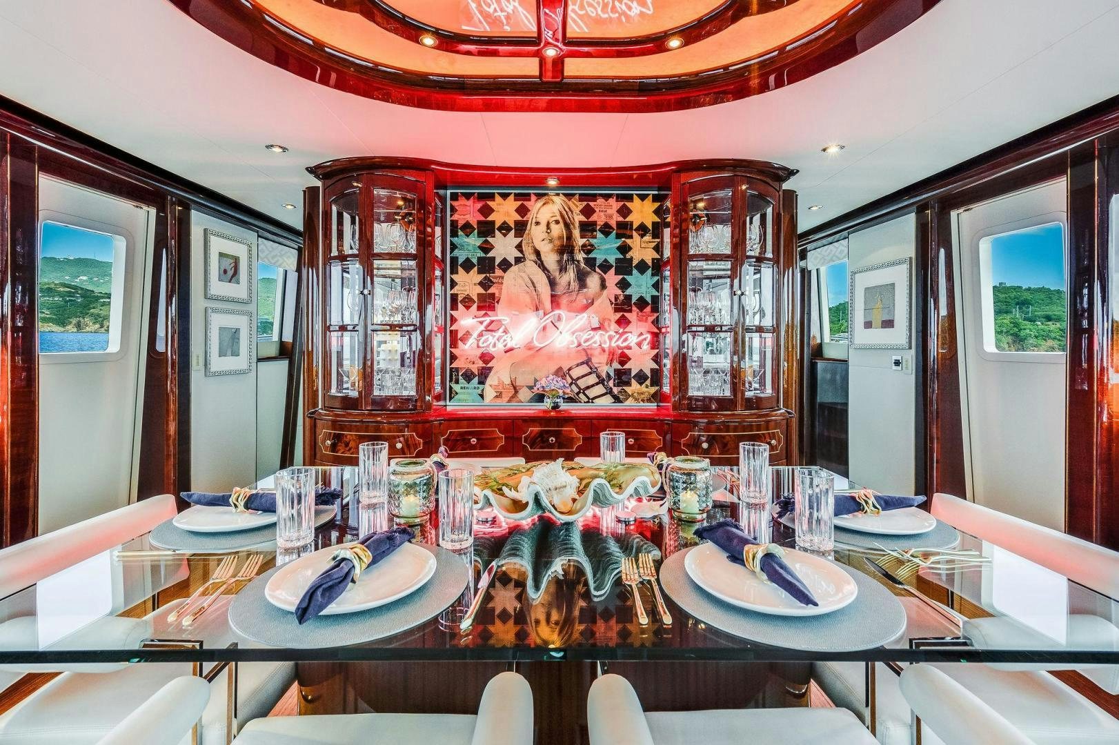 a dining room with a large painting aboard NAMASTAY Yacht for Sale