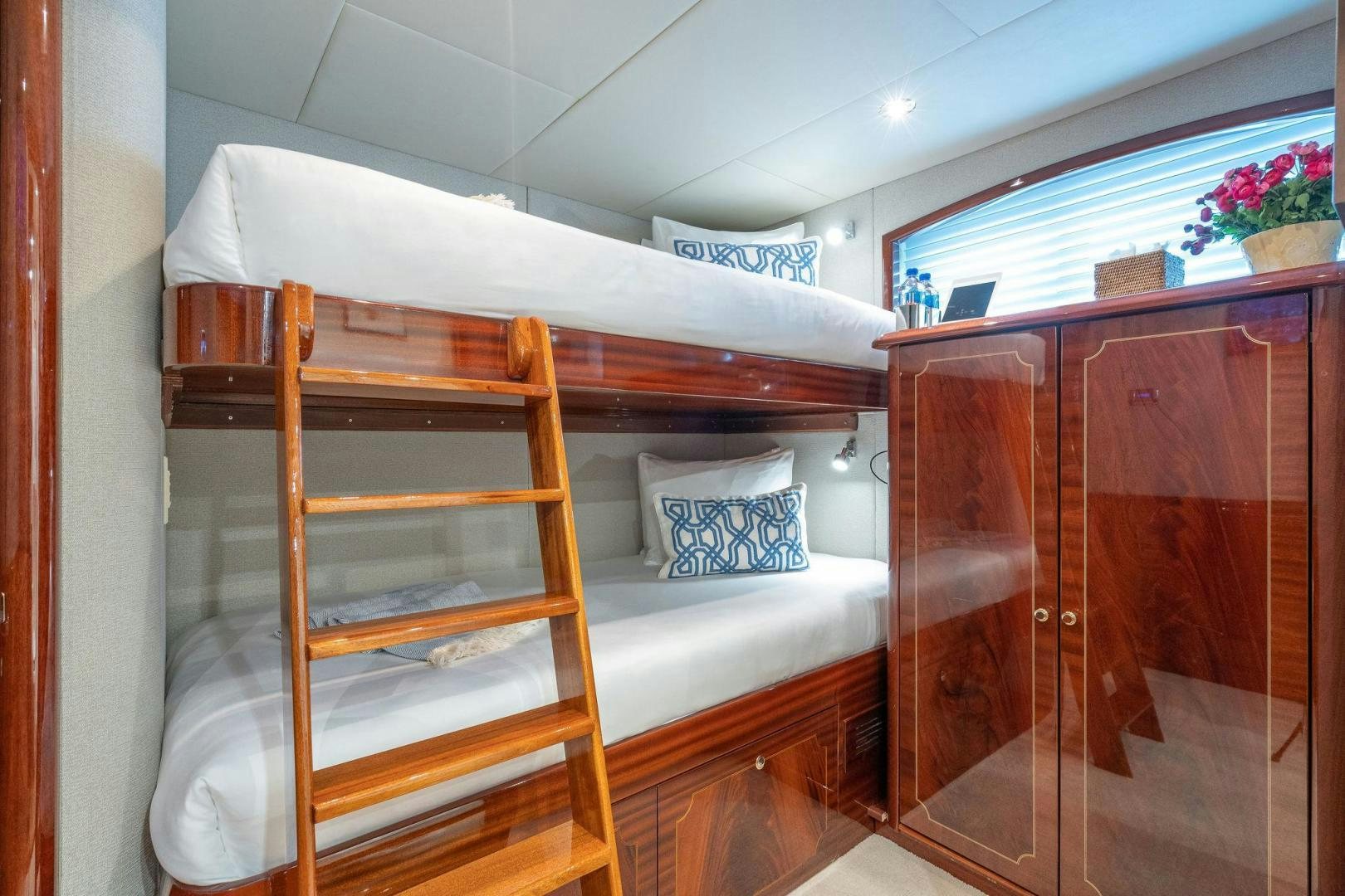 a bunk bed with a wooden frame aboard NAMASTAY Yacht for Sale