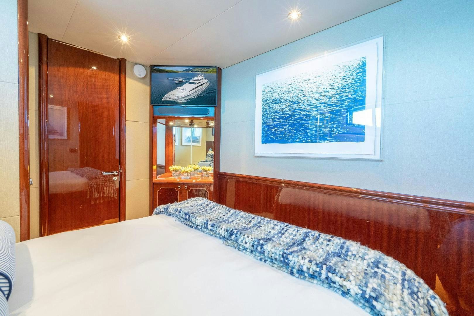 a bed with a blue sheet aboard NAMASTAY Yacht for Sale