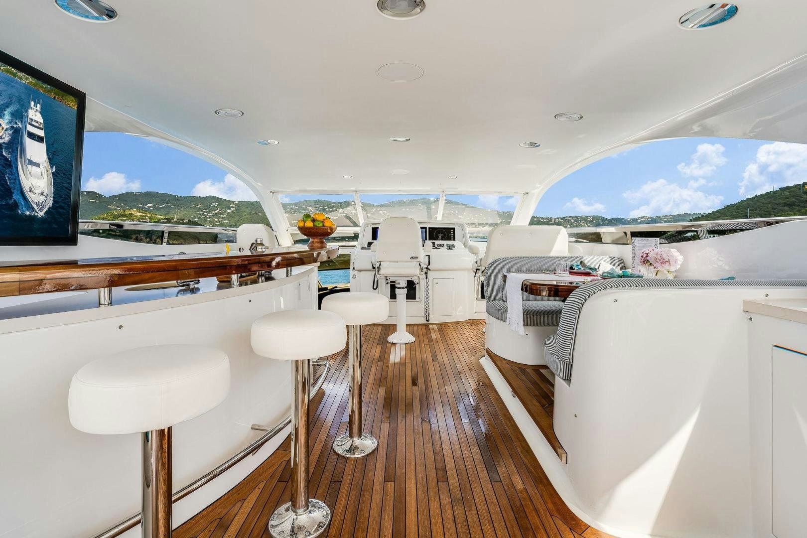 a room with a large window and a large white boat with a wood floor and white cabinets and aboard NAMASTAY Yacht for Sale