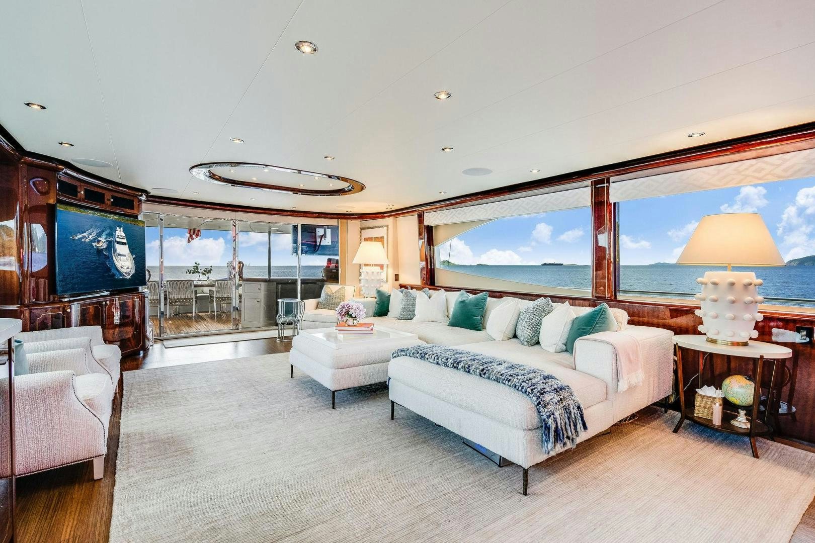 a large living room with a large mirror aboard NAMASTAY Yacht for Sale