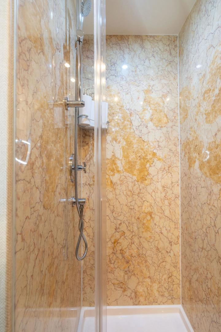 a shower with a glass door aboard NAMASTAY Yacht for Sale