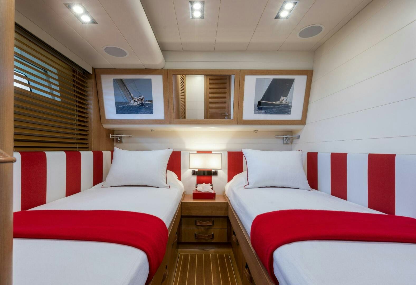 a room with red and white beds aboard LEONARA Yacht for Sale