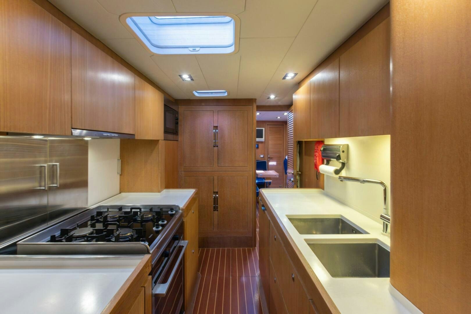 a kitchen with wooden cabinets aboard LEONARA Yacht for Sale