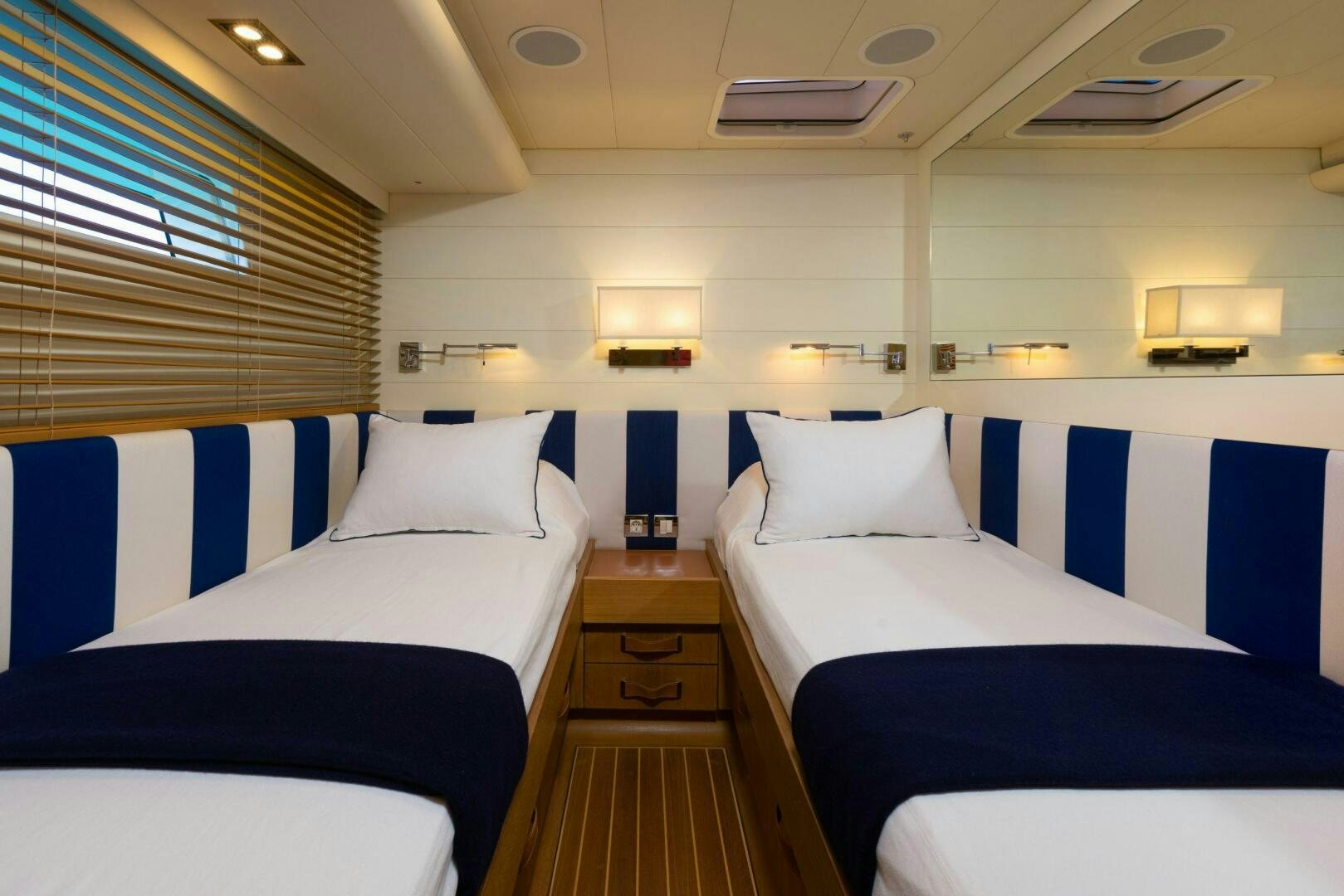 a room with beds and a window aboard LEONARA Yacht for Sale