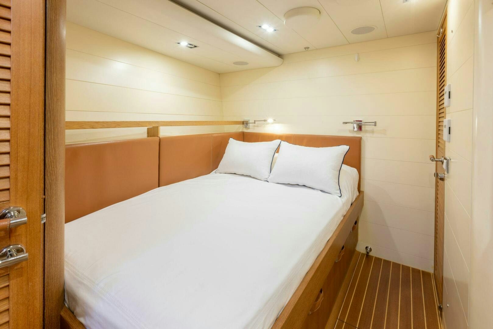 a bed with white sheets aboard LEONARA Yacht for Sale
