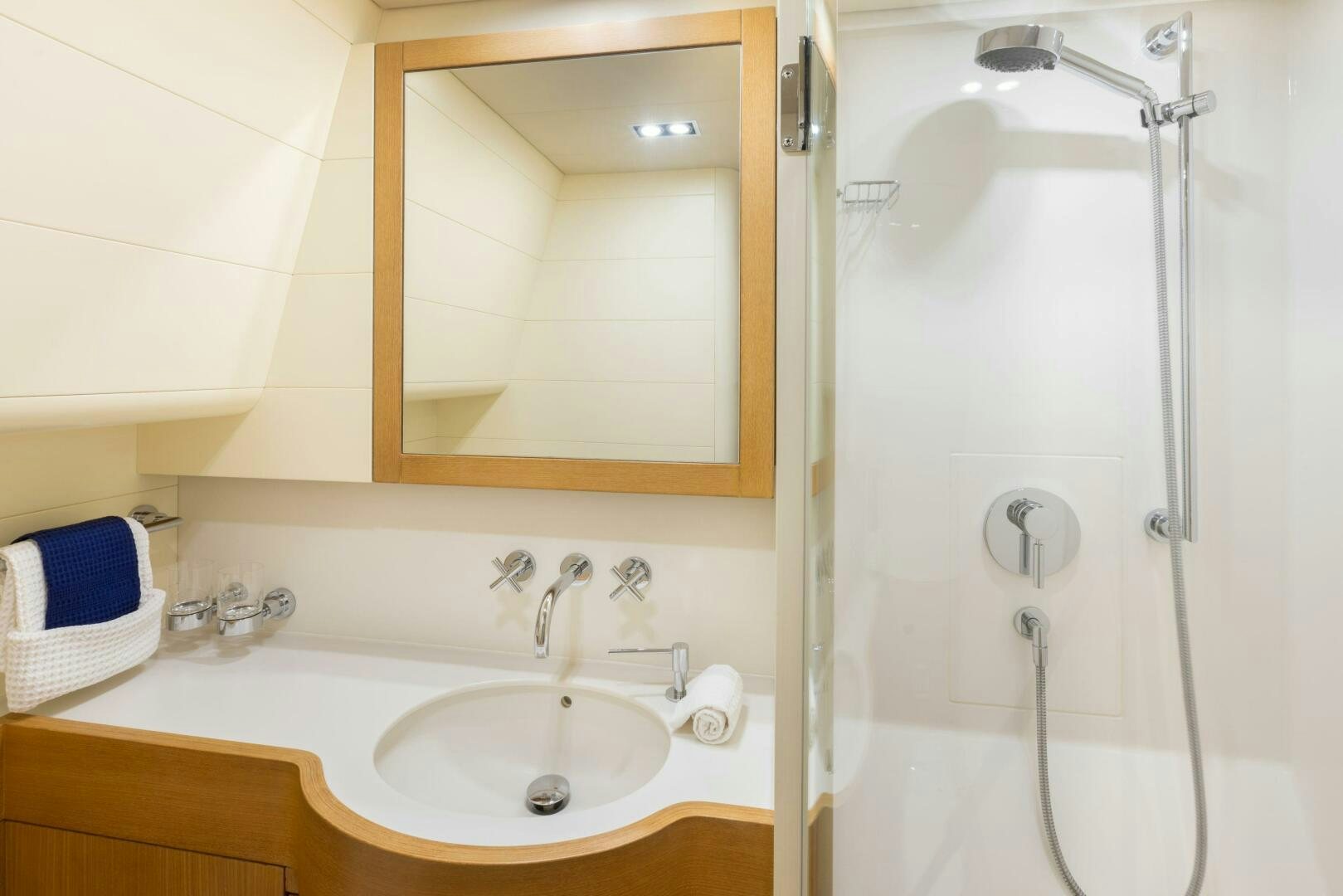 a bathroom with a shower sink and mirror aboard LEONARA Yacht for Sale
