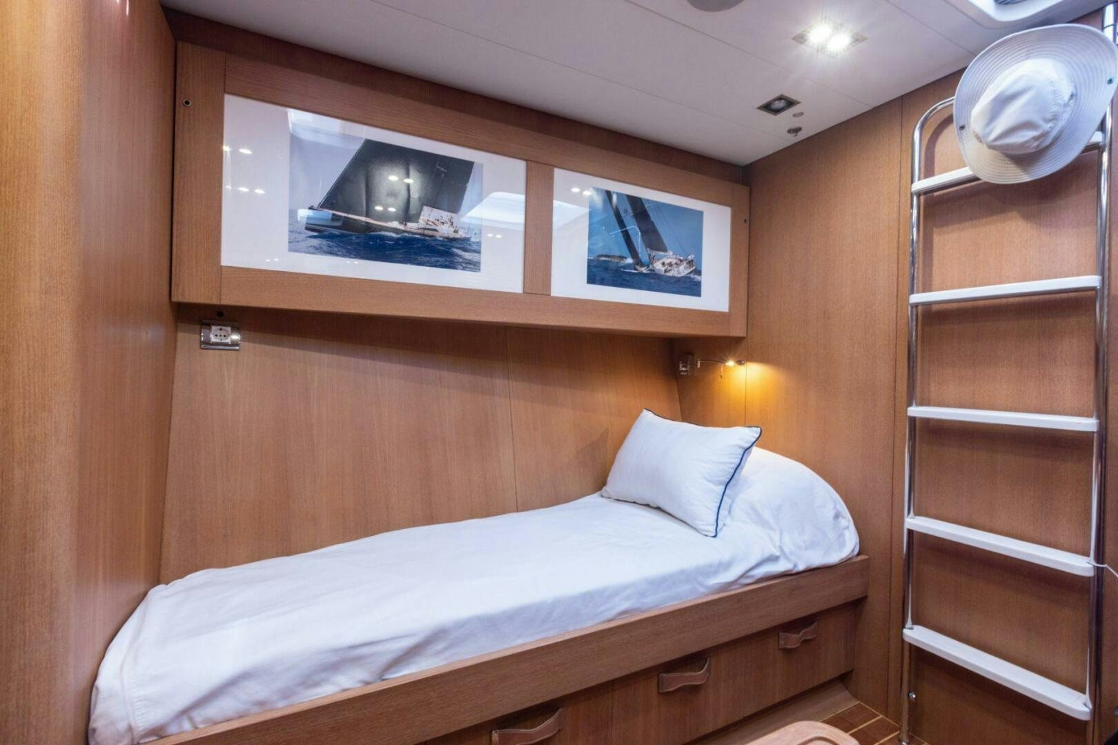 a bed with a mirror above it aboard LEONARA Yacht for Sale