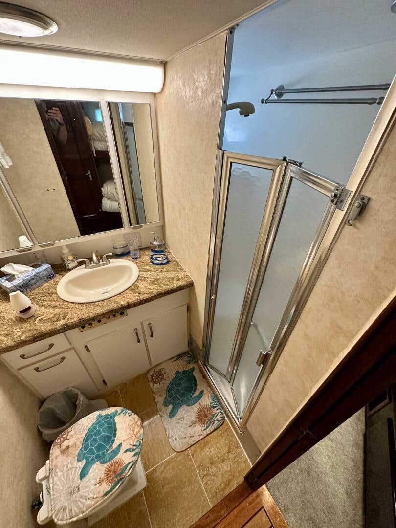 a bathroom with a large mirror aboard CONUNDRUM Yacht for Sale