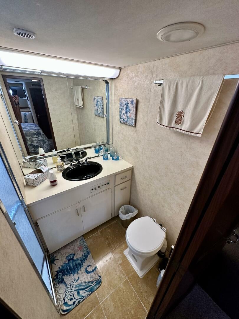 a bathroom with a sink and a toilet aboard CONUNDRUM Yacht for Sale