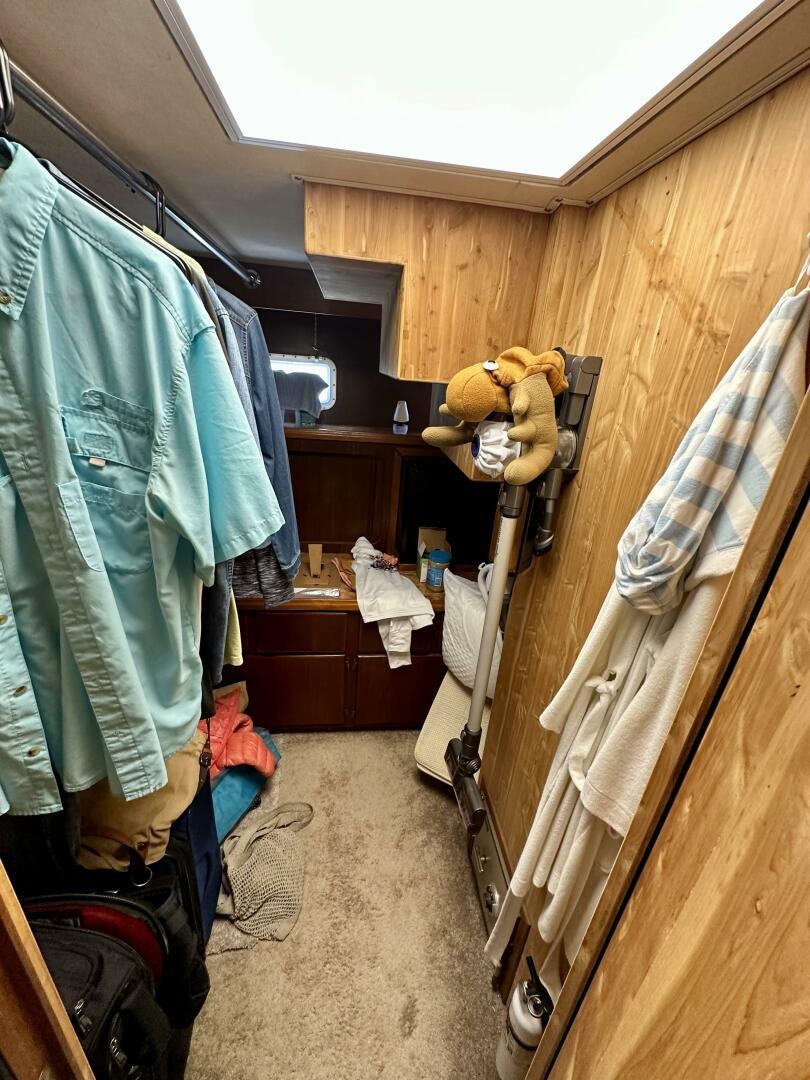 a room with a closet and clothes aboard CONUNDRUM Yacht for Sale