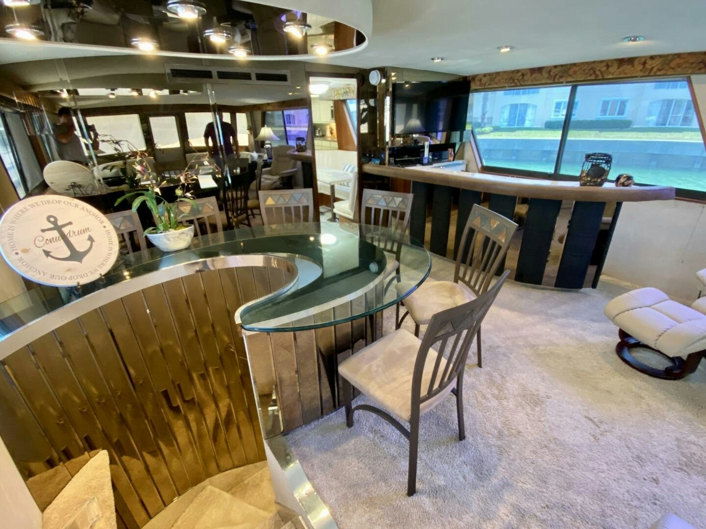 a room with tables and chairs aboard CONUNDRUM Yacht for Sale