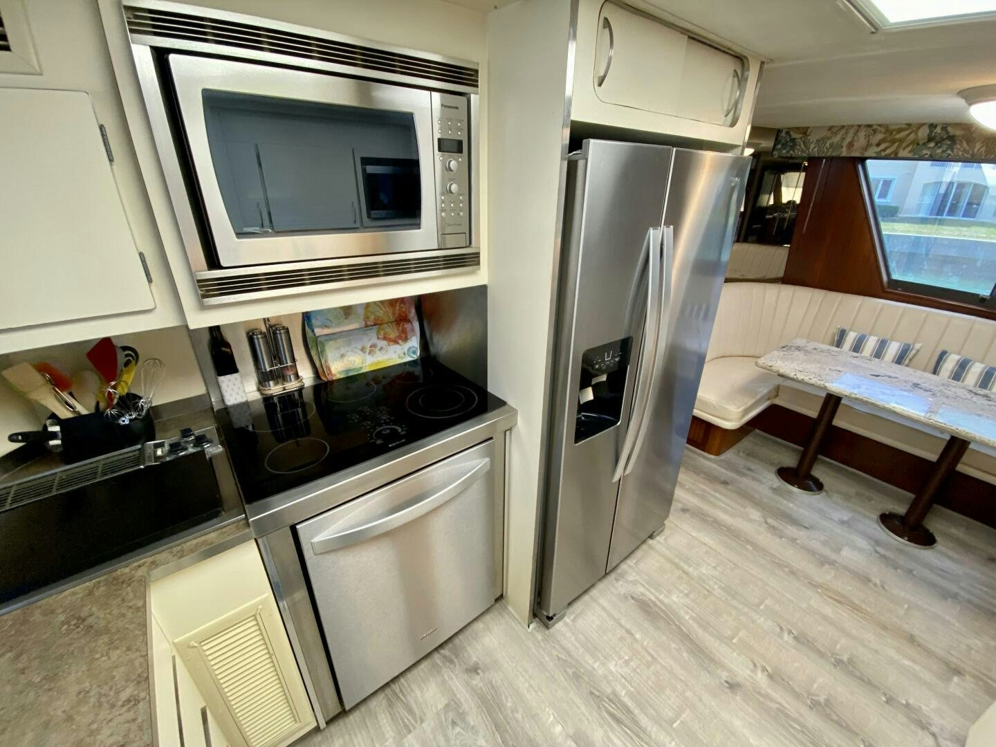 a kitchen with a fridge and microwave aboard CONUNDRUM Yacht for Sale