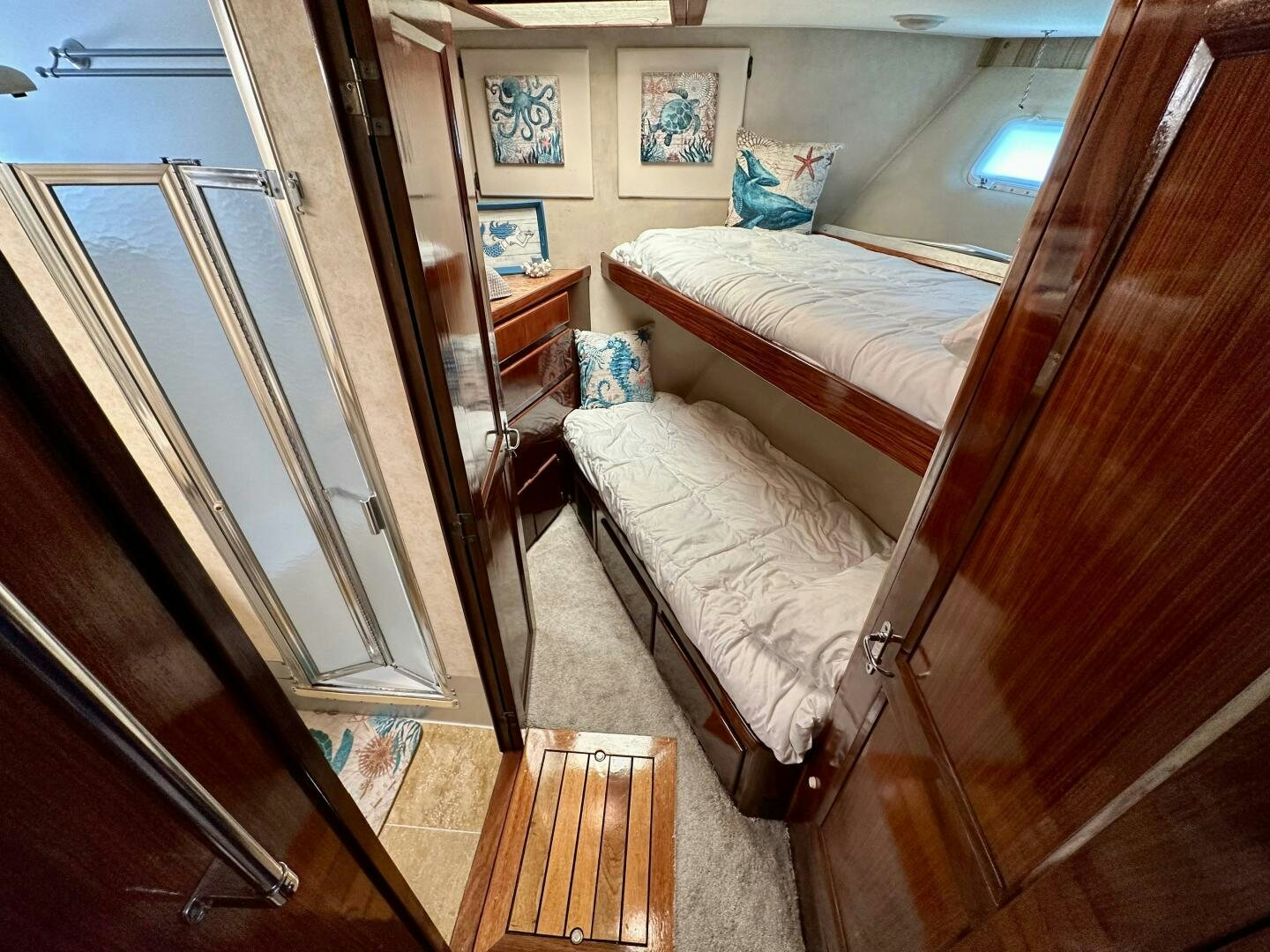 a room with a bed and a mirror aboard CONUNDRUM Yacht for Sale